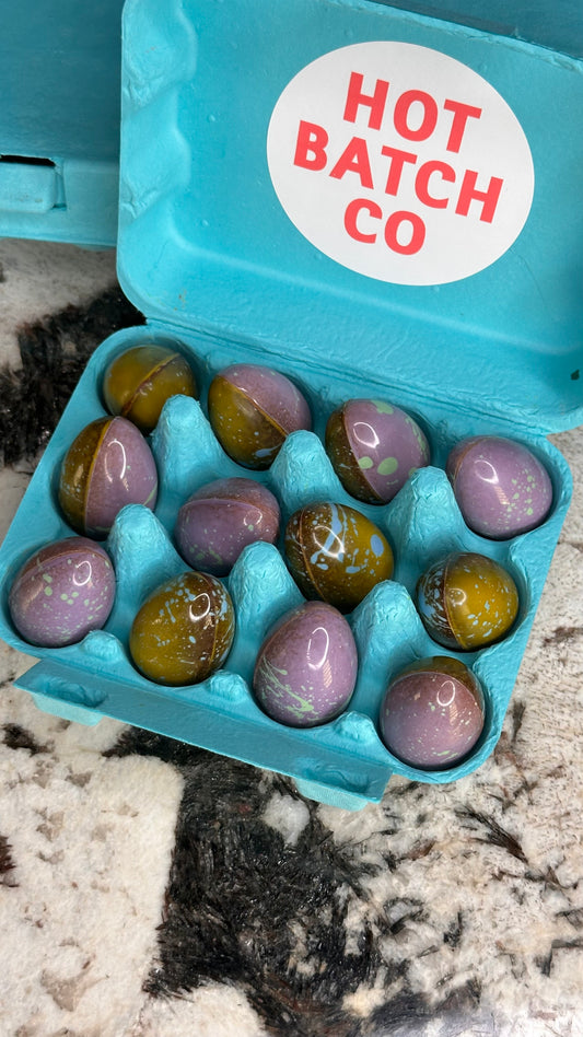 Colorful Easter eggs in a blue carton with 'Hot Batch Co' label.